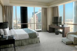Łóżko lub łóżka w pokoju w obiekcie Millennium Plaza Doha