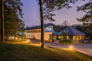a home with a lit up building at night at Park Villa Hotel in Vilnius