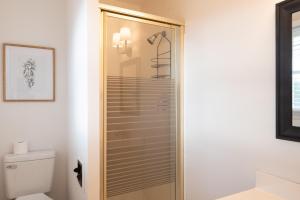 a glass shower in a bathroom with a toilet at Inglewood Cottage in Saint Thomas +43 photos