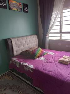 a purple bed in a bedroom with a window at D'TRANUNG Seaview Homestay Pusat Bandar KT in Kuala Terengganu +13 photos