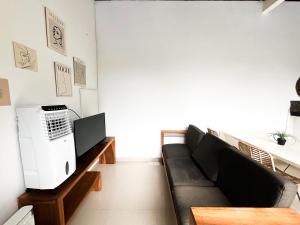 a living room with a couch and a computer at Villa Kita Seminyak in Seminyak