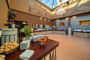 a bakery with a table with food on it at Hotel Gromada Pila in Piła