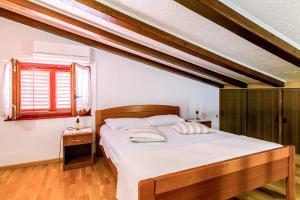 a bedroom with a large bed with white sheets at Elvira - Apartment Bungalow - MPolo in Medulin