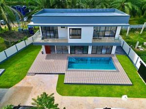 an aerial view of a house with a swimming pool at Dragon Pool Villa Aonang in Ao Nam Mao