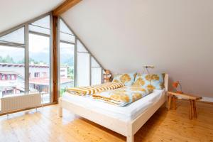 un letto in una camera con una grande finestra di Apartments Sopherl - by myNests ad Aich