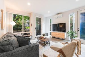 a living room with a couch and a tv at Perch - View on Franklin in Seattle
