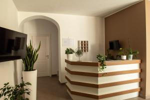 a hallway with potted plants and a stairway at La Cicas Case Vacanze in Marina di Ascea
