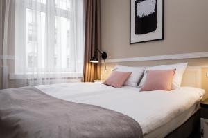 Posteľ alebo postele v izbe v ubytovaní Imagine Apartments