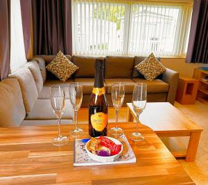 a bottle of wine and three wine glasses on a table at 13 Chorley close in Walton-on-the-Naze