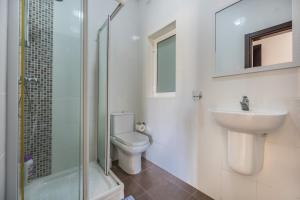 a bathroom with a toilet and a sink and a shower at Central Sliema Modern 2 bedroom Apartment Malta in Sliema +9 photos