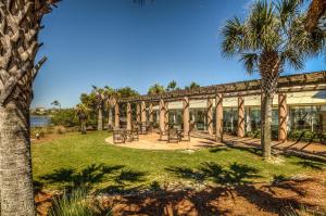 a building with tables and chairs in a park at Florencia 708 by Liquid Life in Pensacola