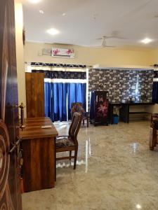 a living room with a desk and a fireplace at SAI HOMESTAY in Agonda
