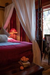 a bedroom with a bed and a table with a book at Srinivas The Royal Residence, Jaipur in Jaipur