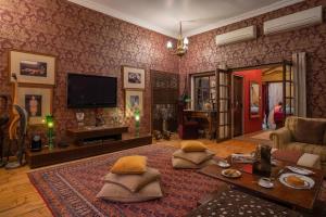 a living room with a couch and a tv at Srinivas The Royal Residence, Jaipur in Jaipur +37 photos