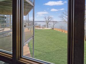 a window with a view of a field of grass at Bayview Sunset Escape at the Lake in Arnolds Park +36 photos