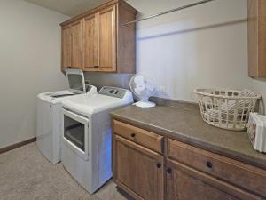 a kitchen with a washing machine and a washer at Bayview Sunset Escape at the Lake in Arnolds Park