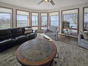 a living room with a couch and a table and chairs at Bayview Sunset Escape at the Lake in Arnolds Park