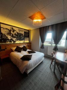 a bedroom with a large bed with pillows on it at au petit quinquin in Céaux