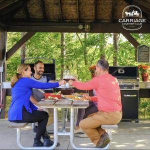a group of people sitting at a table eating food at Newly Renovated Ski-In Ski-Out 1-Bedroom Condo with Pool, Gym, Sauna by Horseshoe Valley in Edgar