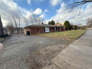 a house with a driveway in front of it at Newly Renovated Gem Fenced Backyard 2 Full Baths in Allen Park