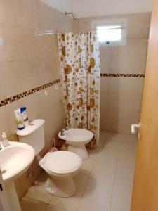 a bathroom with a toilet and a sink and a shower at LOS Teros dptos 3 5 3 4 0 9 2 8 1 5 in Villa María