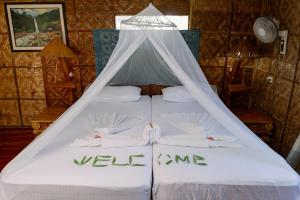 Un pat sau paturi într-o cameră la Polaris Beach and Dive Resort Inc