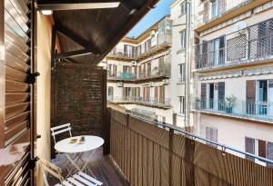 a balcony with a table and chairs on a building at La Casa delle Dee - Self Check-in in Bologna