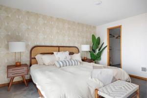 a bedroom with a large bed with white sheets and pillows at Perch - Sierra Retreat 47 in Coupeville +42 photos