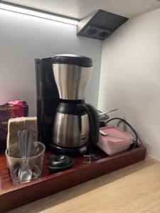 a coffee maker sitting on a wooden shelf at Free Parking Private ROOM with Balcony, 10mins to Helsinki center in Helsinki