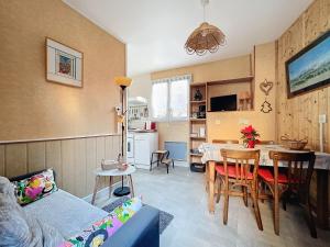 a kitchen and living room with a table and chairs at Maison des Bains in Allevard