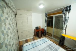 a small bedroom with a bed and a shower at Apartamento La Merced in La Merced +4 photos