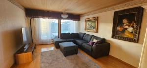 a living room with a couch and a tv at Anttoninvahe 7 130m2 with garden and sauna etc in Rauma