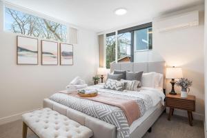 a bedroom with a large bed and a window at Perch - The Ashworth 69 in Seattle