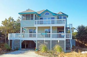 a large house sitting on top of a beach at WH1020- Crab Quarters in Corolla