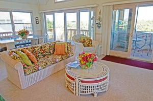a living room with a couch and a table at WH1020- Crab Quarters in Corolla