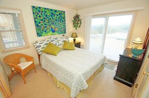 a bedroom with a bed and a window at WH1020- Crab Quarters in Corolla +15 photos