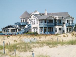 a large house sitting on top of a beach at Y1485- Sunnybank in Corolla