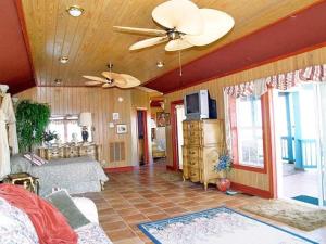 a living room with a bed and a ceiling fan at Y1485- Sunnybank in Corolla