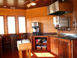 a kitchen with wood paneled walls and a counter top at Y1485- Sunnybank in Corolla