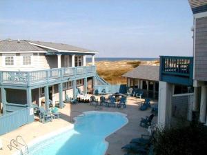 a large house with a swimming pool and a patio at Y1485- Sunnybank in Corolla