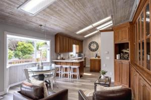 a kitchen and living room with a table and chairs at Coastal Hideaway in Fort Bragg
