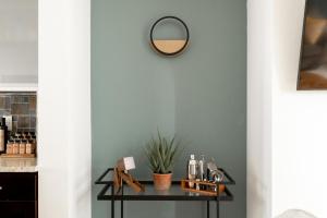 a mirror on a wall next to a table with cosmetics at Urban Oasis - Rooftop Delight - Peloton - RiNo in Denver +27 photos