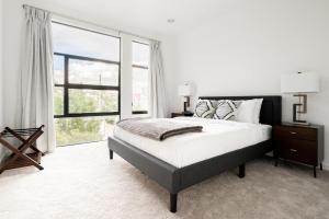 a bedroom with a bed and a large window at Urban Oasis - Rooftop Delight - Peloton - RiNo in Denver
