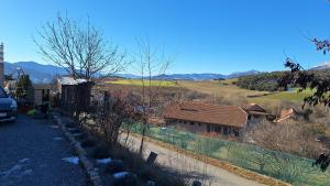 a house with a fence next to a field at Gîte l'hippocampe in Jarjayes