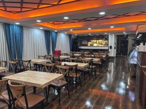 a dining room with wooden tables and chairs at Avist Hotel Avcılar in Avcılar