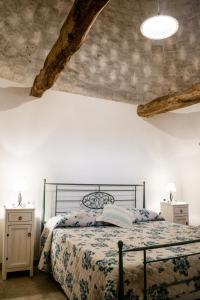 a bedroom with a bed and two night stands at B&B Trulli Donna Isabella in Locorotondo