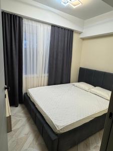 Ένα ή περισσότερα κρεβάτια σε δωμάτιο στο Alp Apart Hotel