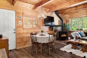 a dining room with a table and a fireplace at Perch - Antler House in Ashford +41 photos
