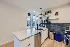 a kitchen with a sink and a counter top at Perch - Wallingford Comfort in Seattle +21 photos