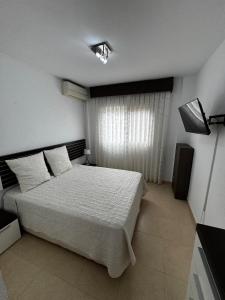 a bedroom with a large bed and a window at Apartamento en Cartagena in Cartagena